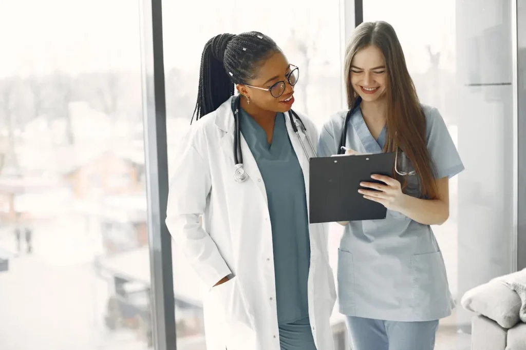 two healthcare professionals brainstorming ways to conduct fair performance reviews 