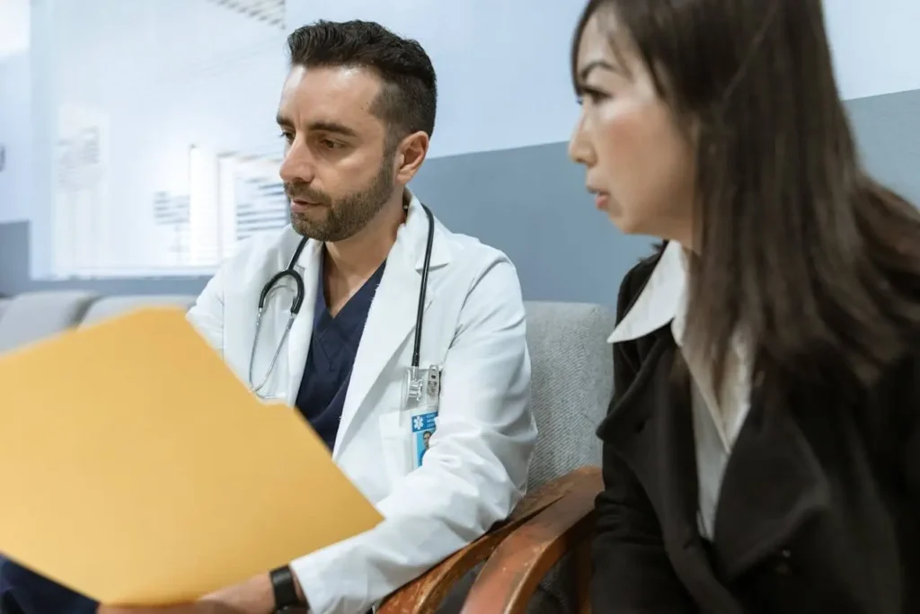 Doctor discussing performance review challenges in healthcare with HR Director