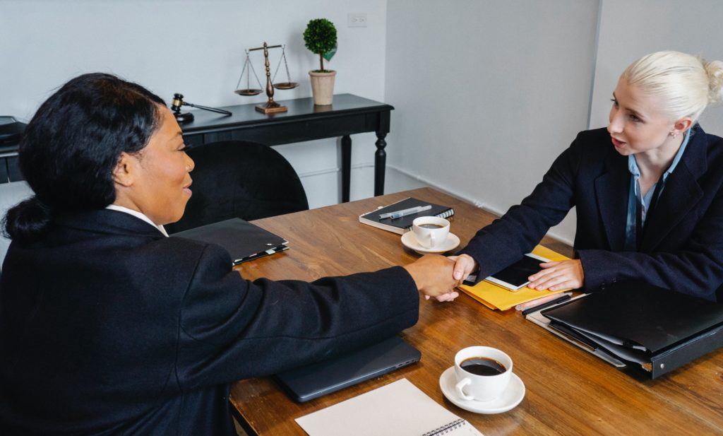 Women shaking hands after one-on-one meeting