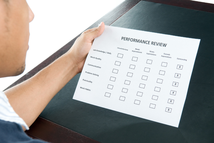 Man holding performance evaluation form