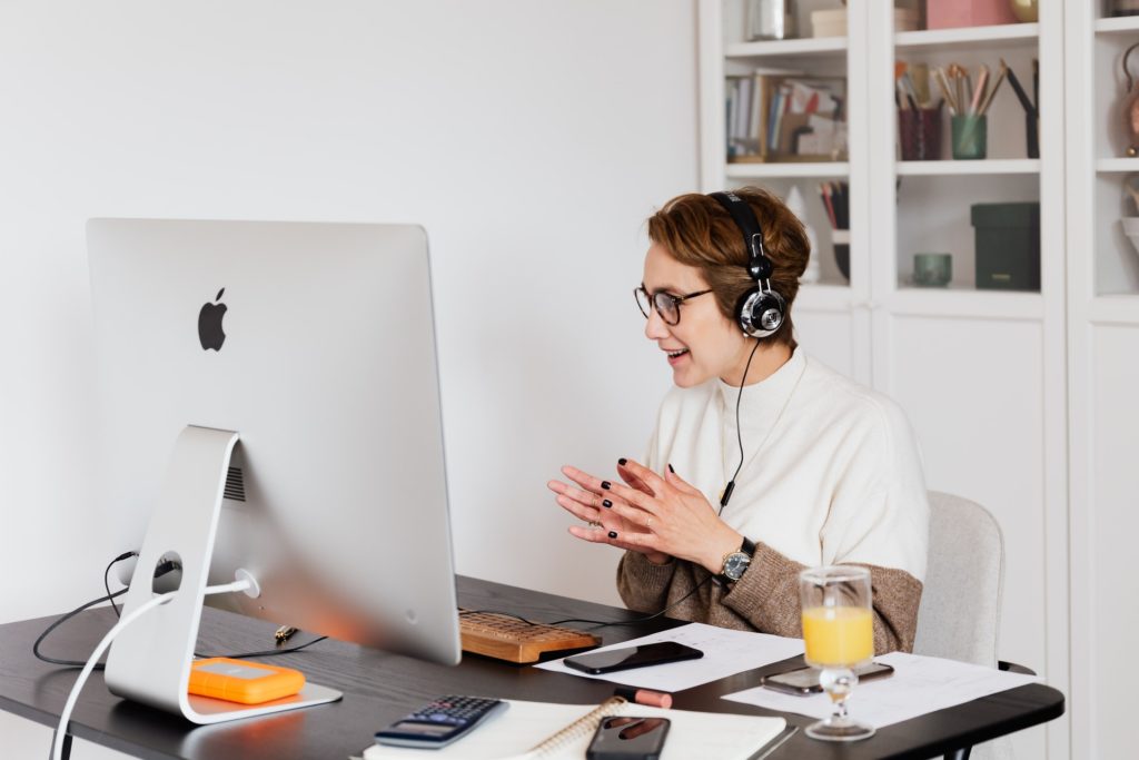 Woman discussing employee engagement ideas on video call with headphones