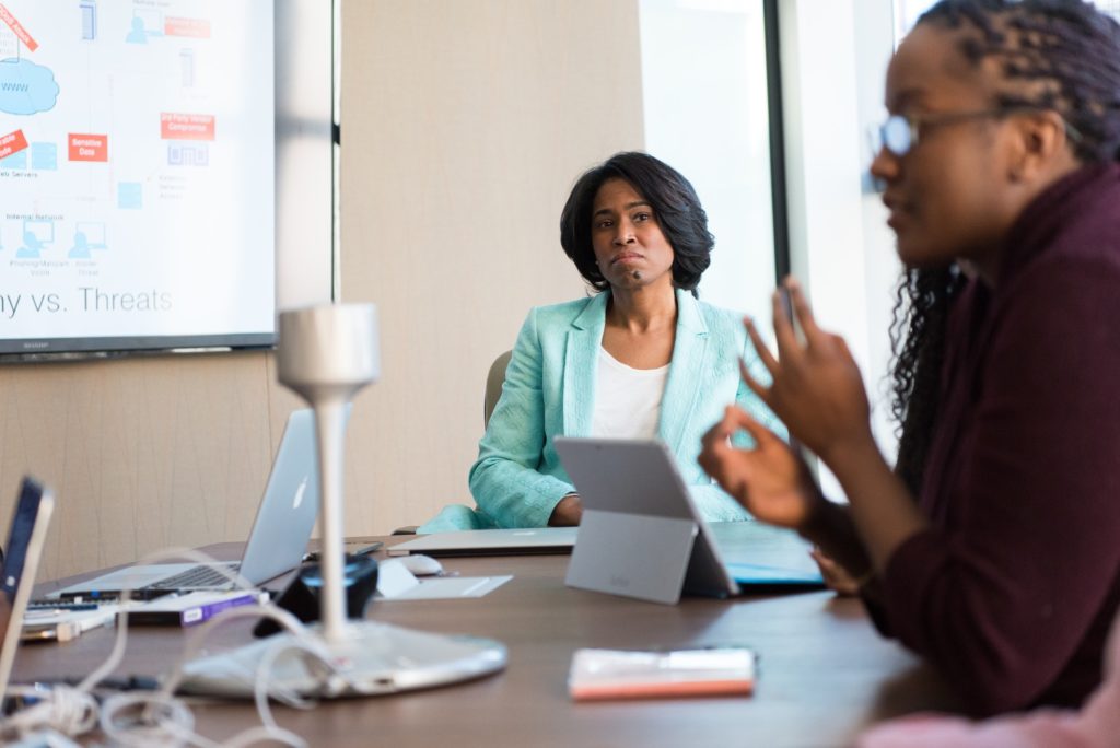 Two Black women in meeting discussing leadership strategy