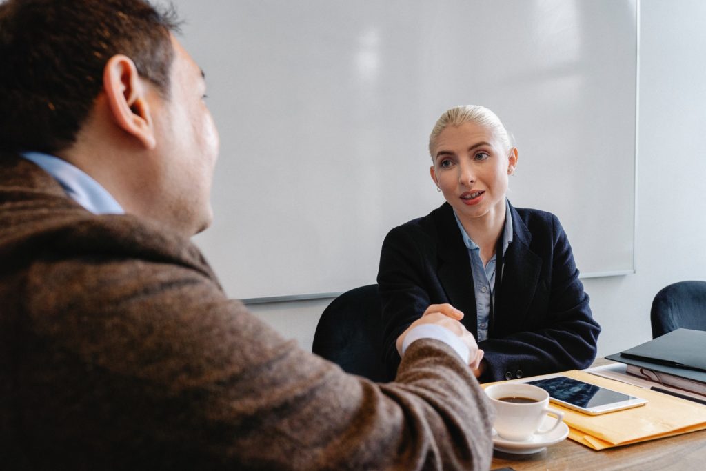 Employee and manager shake hands during performance review