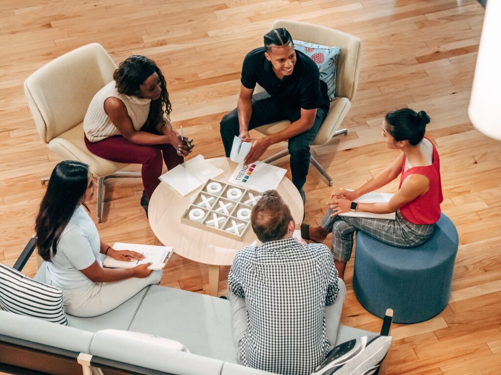 five diverse colleagues meet to discuss employee lsitening