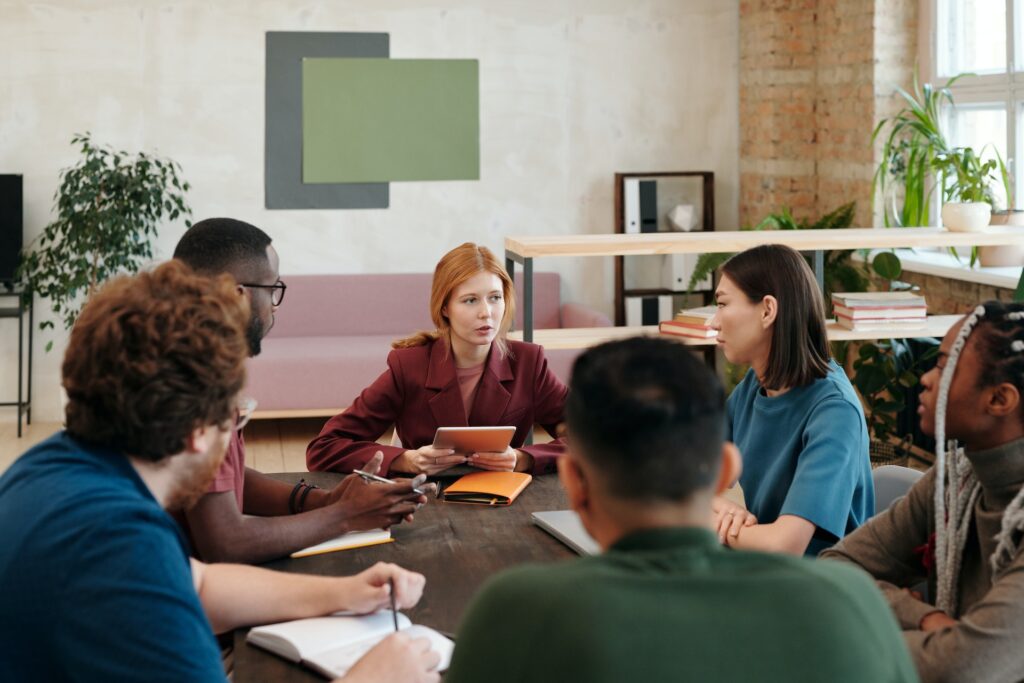 Diverse group of colleagues meet in an office to talk about employee sentiment