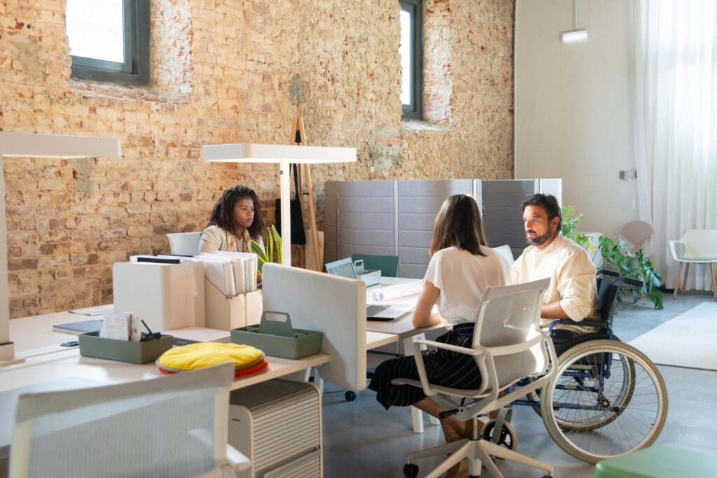 Employees talking at their desks