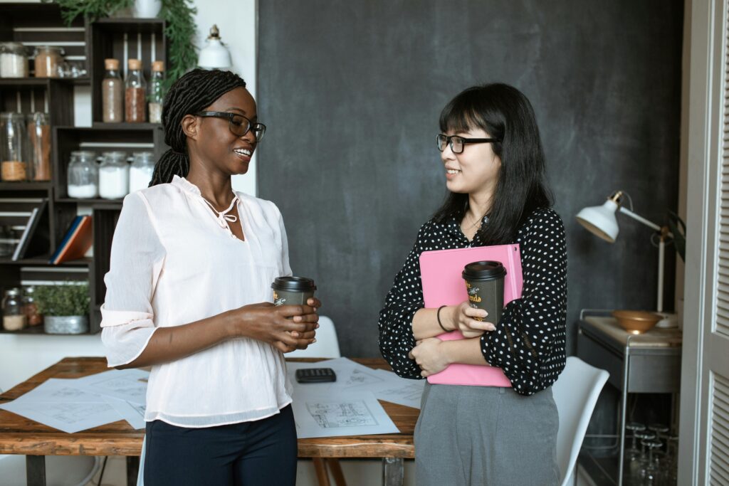 Two women discussing their career development plan