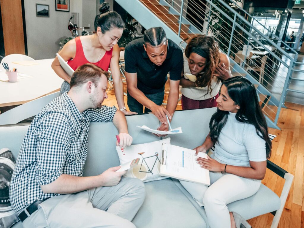 Employees looking over HR memo about 360 reviews