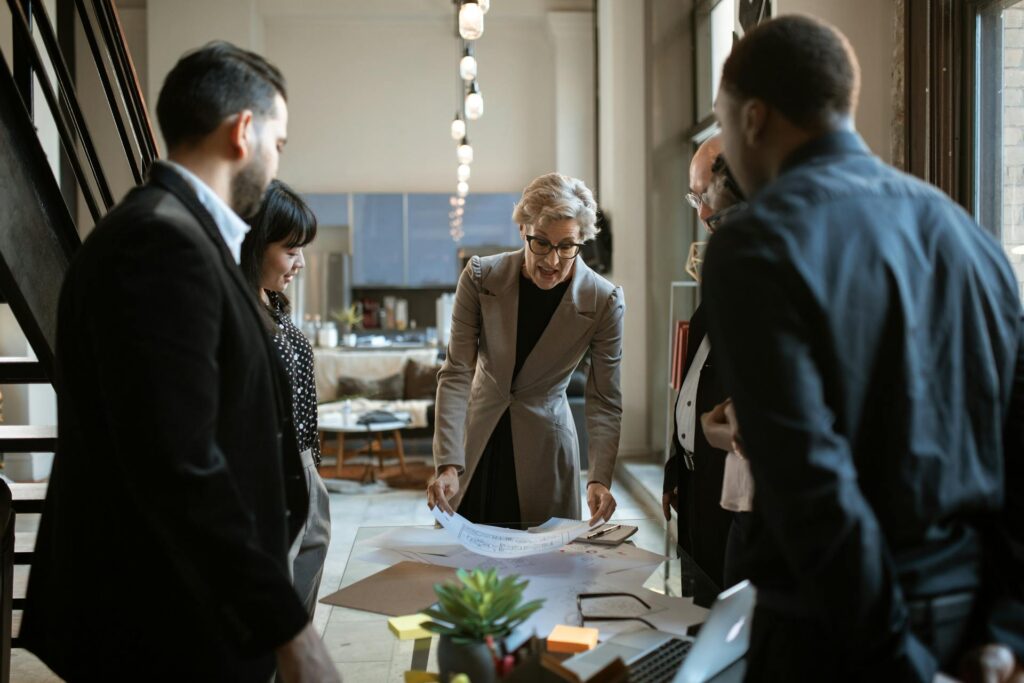 Talent acquisition specialist meeting with managers to discuss hiring strategy