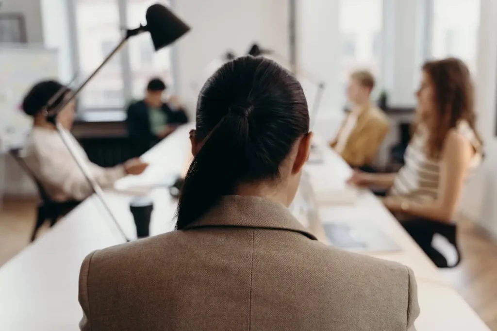 Employee providing confidential feedback to teammates