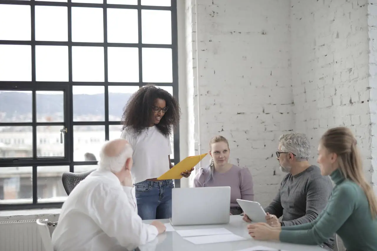 employees-collaborate-in-a-modern-office-setting-with-laptops-and-documents