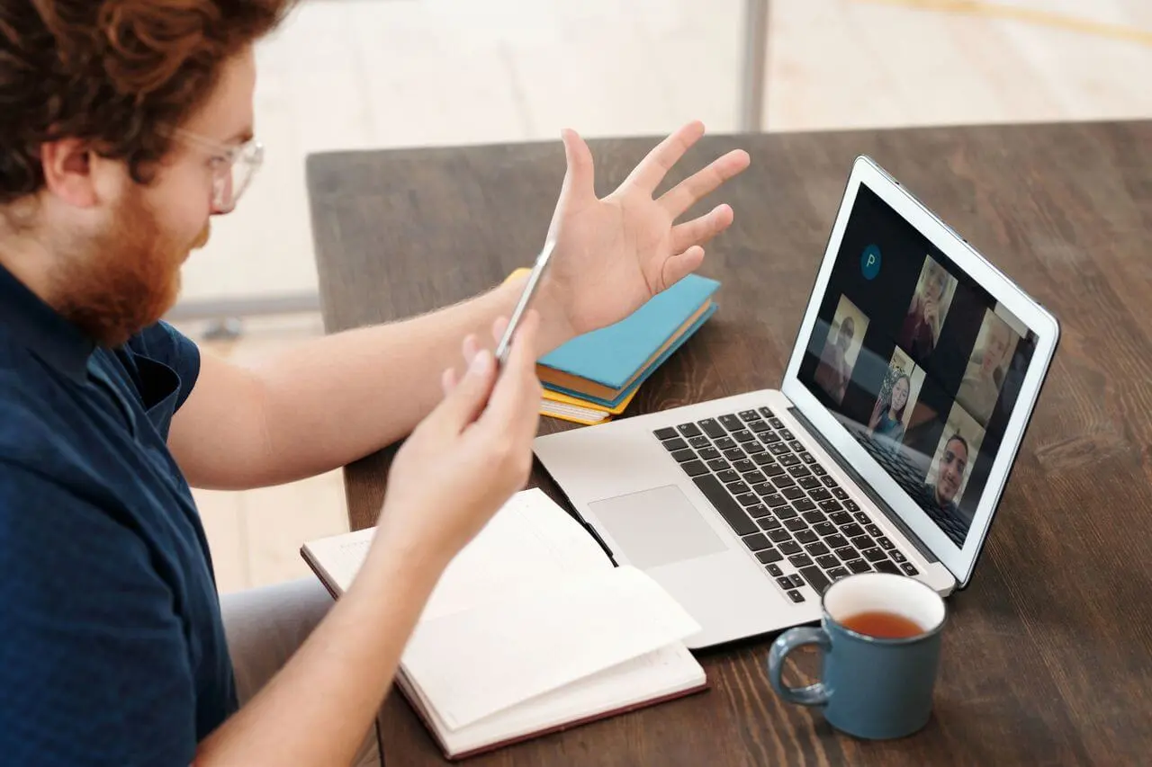 man-engaged-in-team-meeting-from-office Virtual team meeting