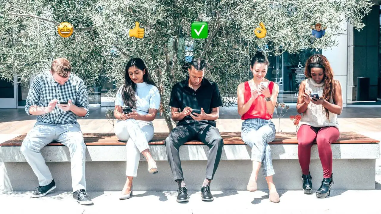 five-people-sitting-outdoors-using-smartphones