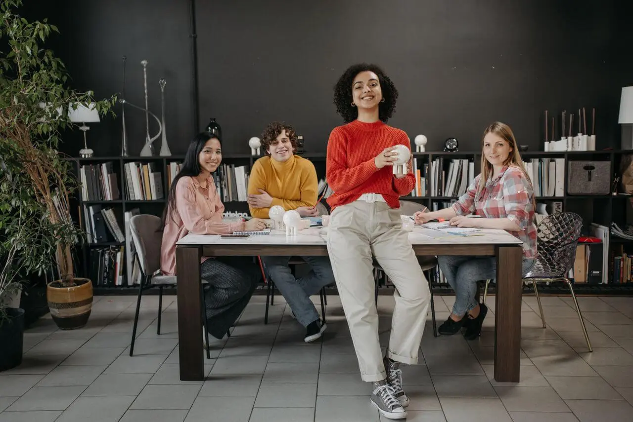 small-team-smiling-around-work-table